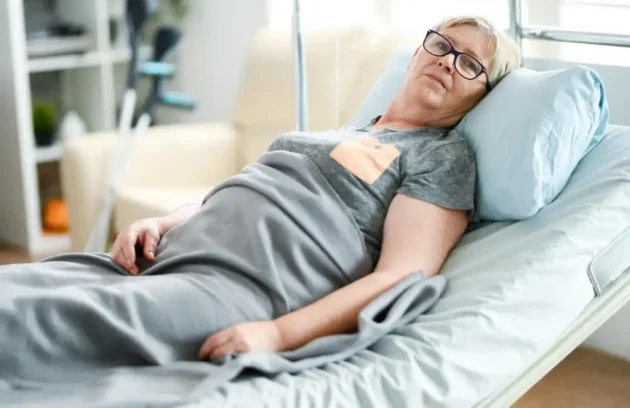 Older woman resting in an adjustable bed as part of a pressure-relief care routine showing **how to prevent bedsores**.