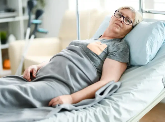 Older woman resting in an adjustable bed as part of a pressure-relief care routine showing **how to prevent bedsores**.